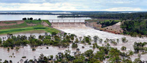 Water rushes over the Fairbairn Dam spillway at Emerald in this aerial photo taken on Thursday. Water rushes over the Fairbairn Dam spillway at Emerald in this aerial photo taken on Thursday.